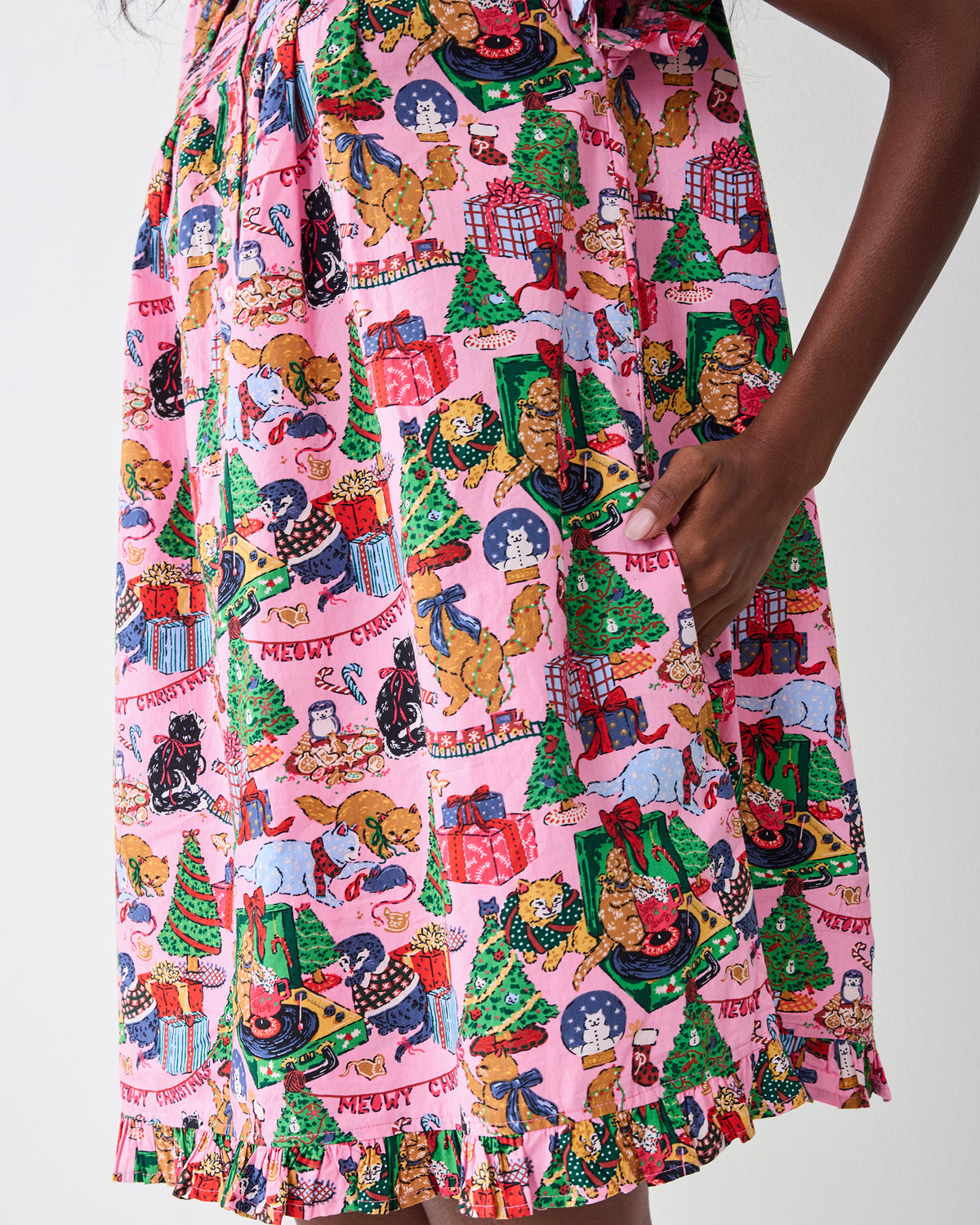Close-up of the Candy Pink Meowy Christmas pintuck nightgown print, gathered fabric, side pocket, and ruffled hem.