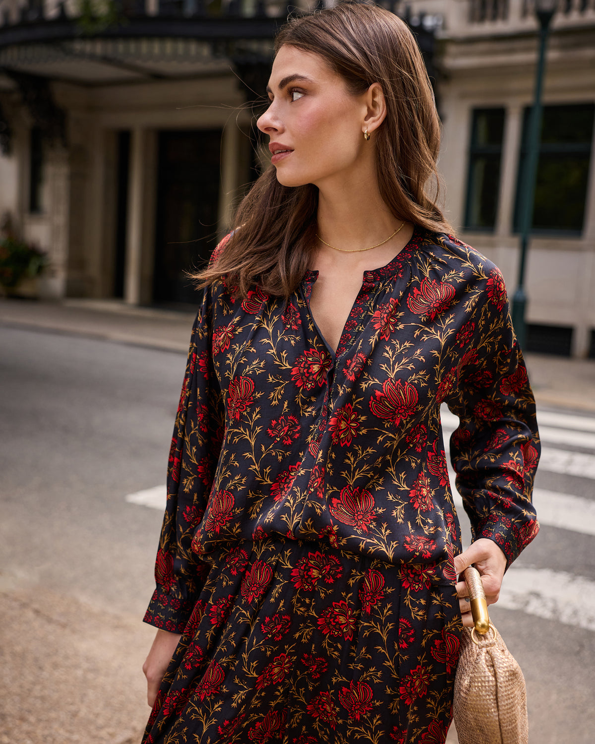 Angled front view of the Midwinter Bloom Drew blouse showing the V-neckline, button placket, long sleeves, and floral print.