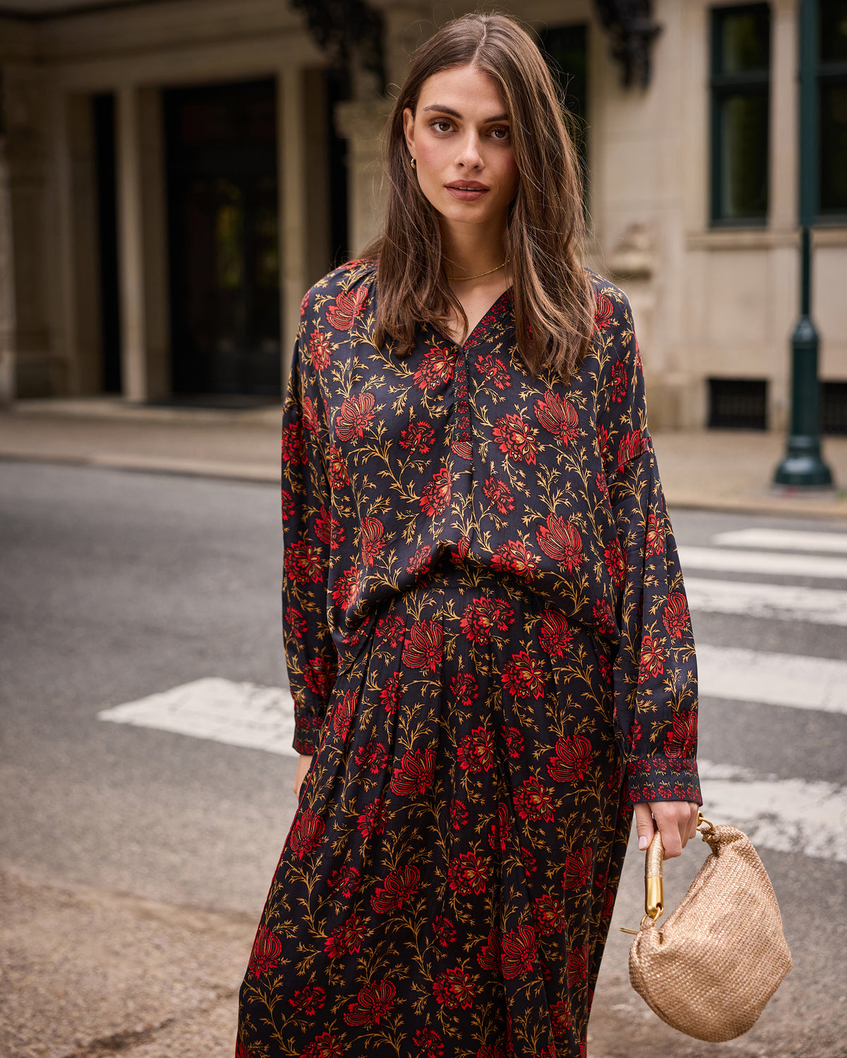 Front view of the Midwinter Bloom Drew blouse with its floral print, worn with a matching long skirt.