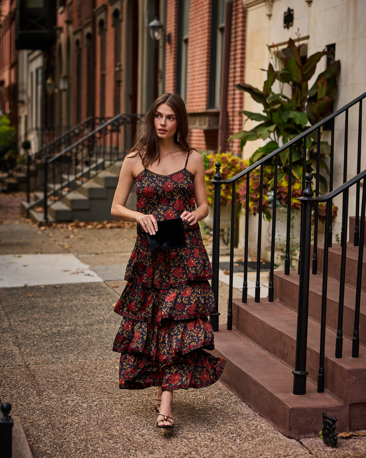 Person wearing the Noelle Set, a floral-print camisole and tiered maxi skirt, outdoors.