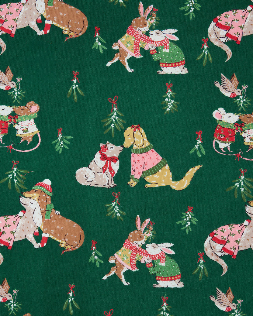 Close-up of the green Mistletoe Kiss print featuring illustrated dogs, cats, rabbits, birds, and mistletoe sprigs.