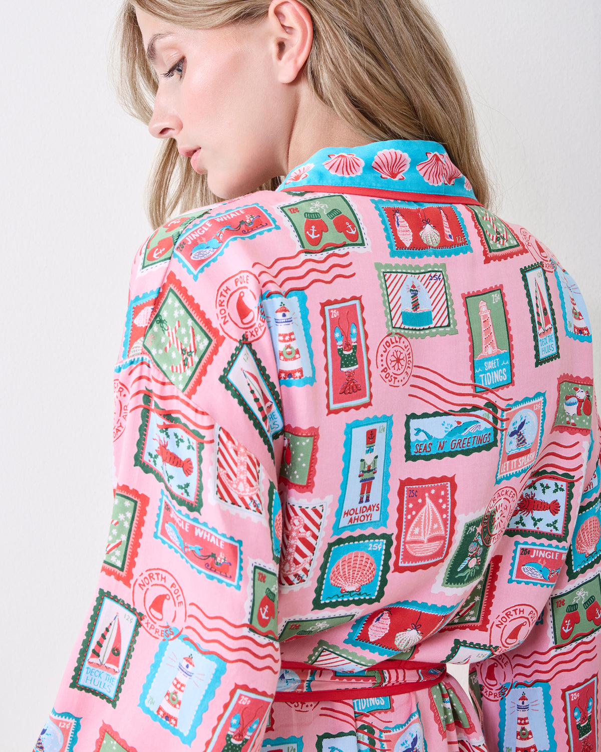 Back view close-up of the pink Nautical Stamps Eco Satin Robe, showing the collar, belt, and holiday stamp print.