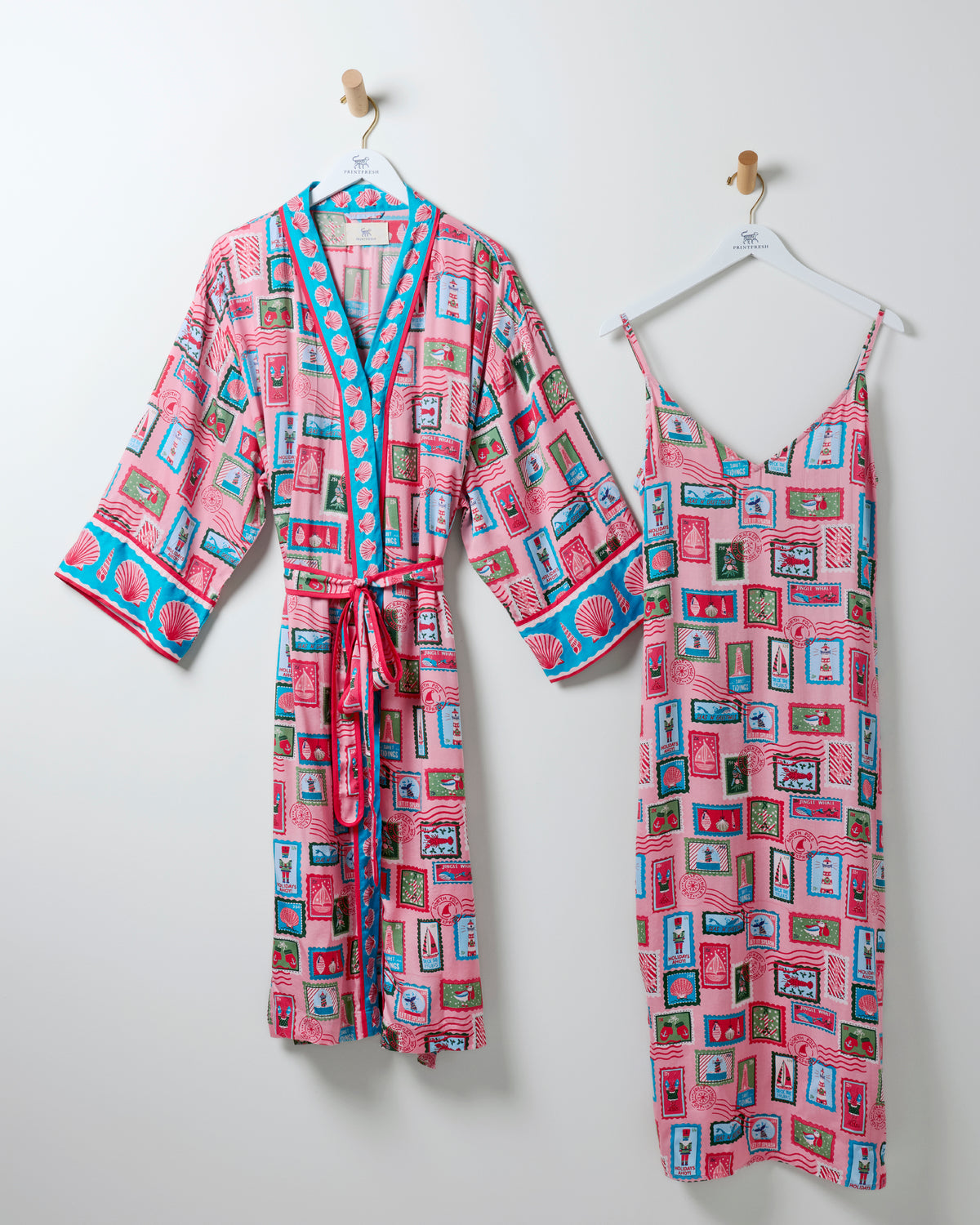 Nautical Stamps robe and matching sleeveless nightie hanging side by side in a pink stamp-patterned print.