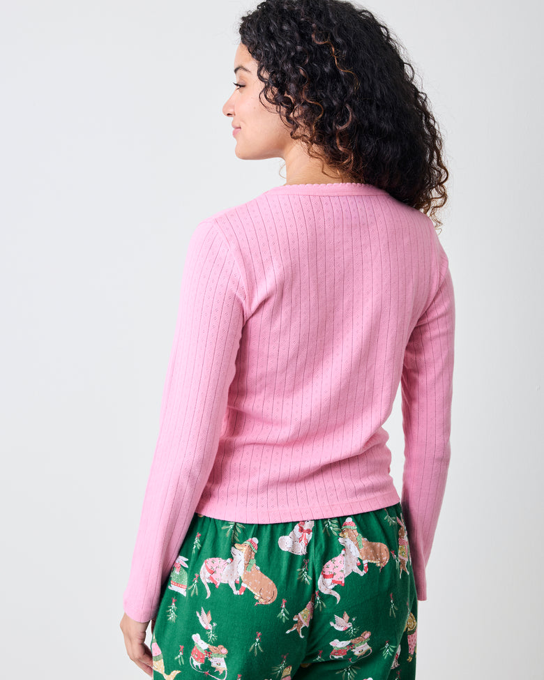 Back view of the pink taffy long-sleeve pointelle top with green patterned pajama pants.