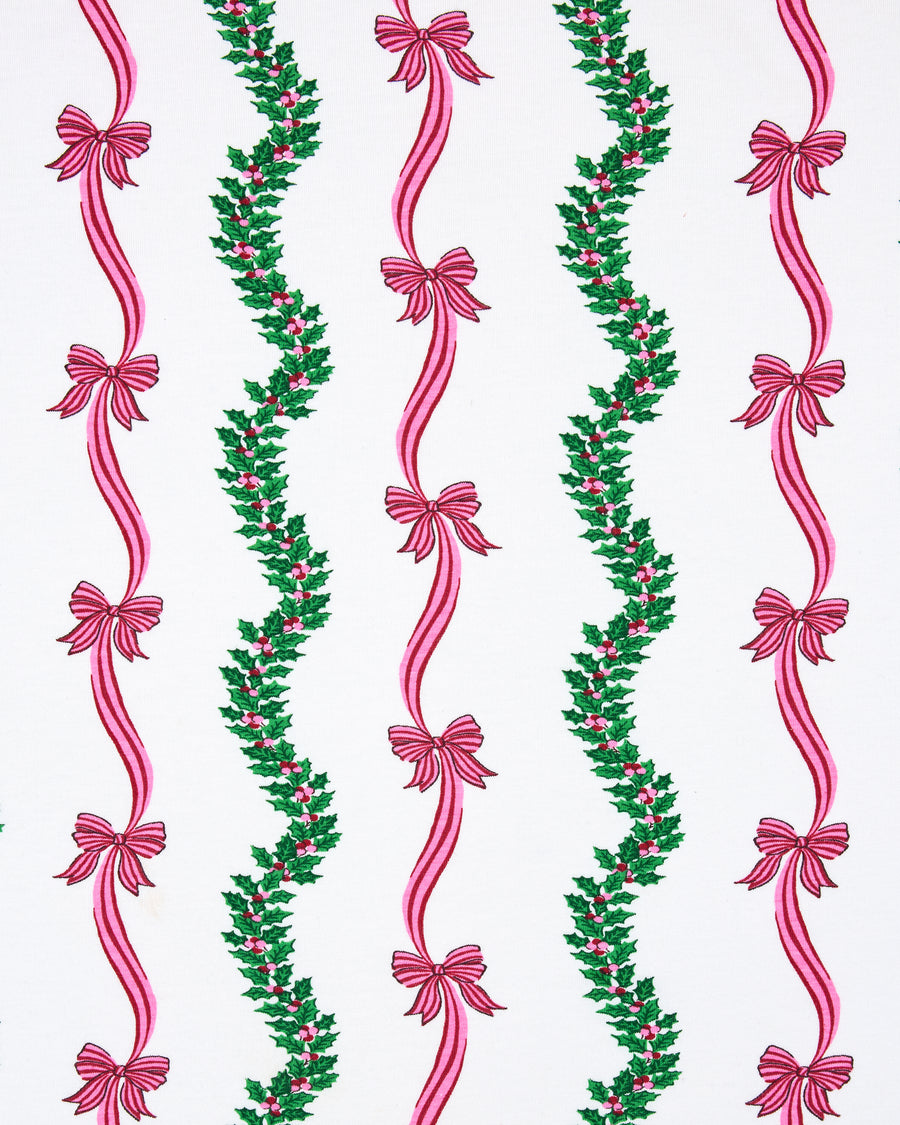 Flat view of the Ribbons & Bows Vanilla Cream print, showing repeated vertical green garlands and pink ribbon bows.