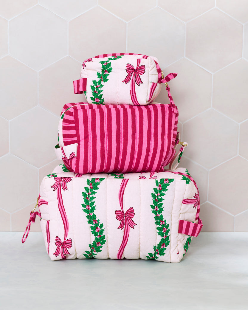 Three quilted pouches stacked by size, showing the Ribbons & Bows print and a shoulder strap.