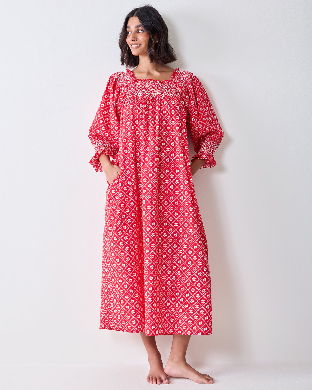 Front view of the red patterned Parker nightgown on a person, showing its long loose silhouette and long sleeves