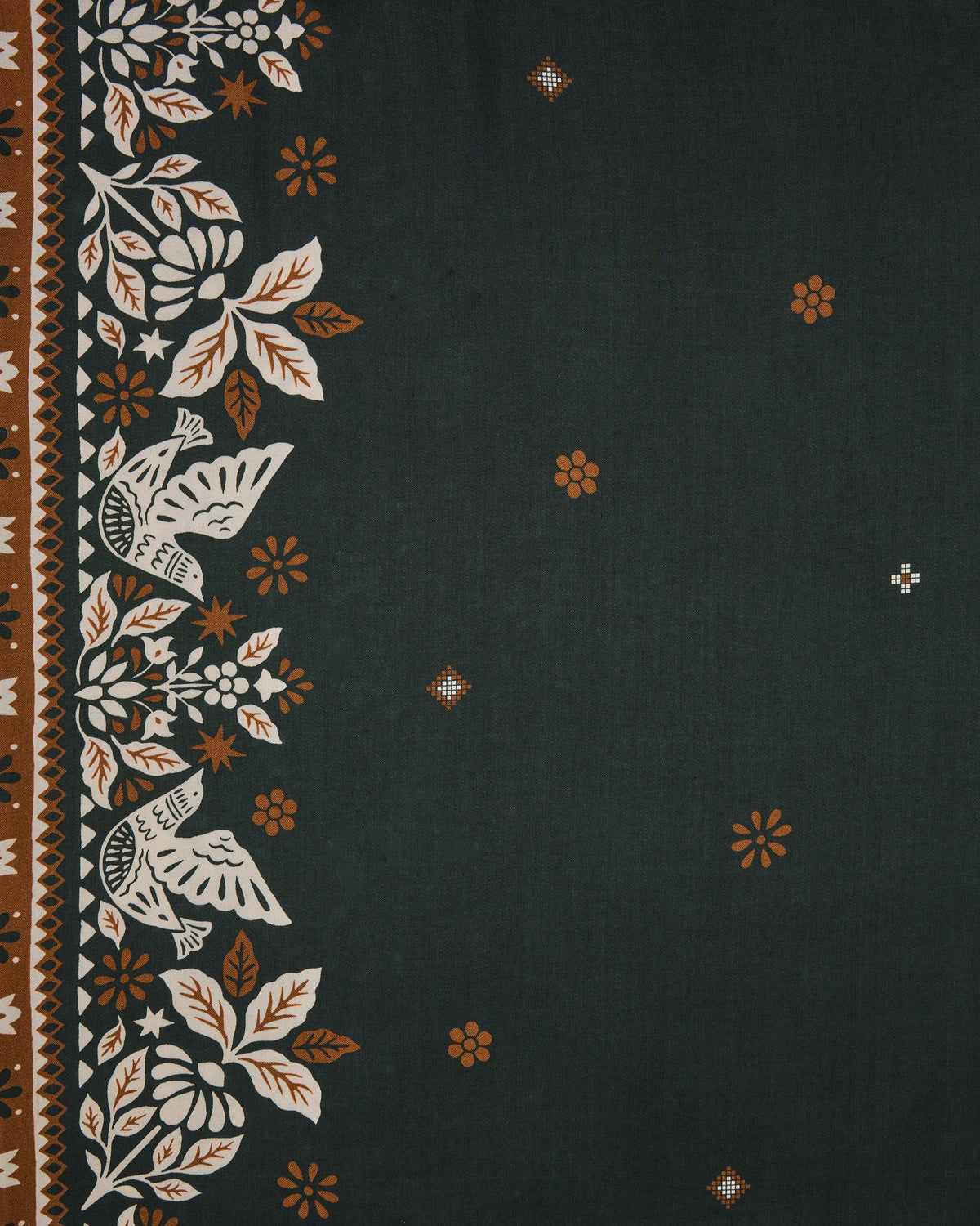 Close-up swatch of the Solstice Tapestry print with floral border motifs, geometric stripes, and small scattered flowers on a dark green background.