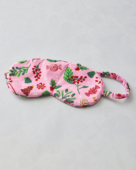 Pink eye mask with a candy and holiday motif and an elasticized matching strap.