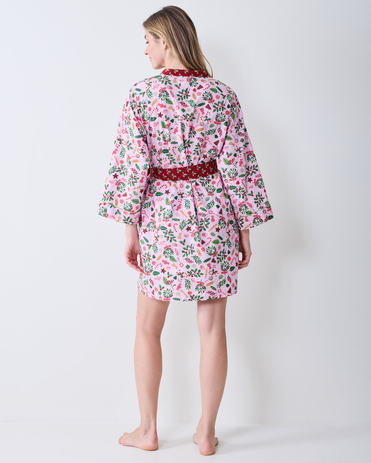 Back view of the Sweet Tooth Getting Ready Robe in Candy Pink, showing the full pink holiday print and red waist belt.