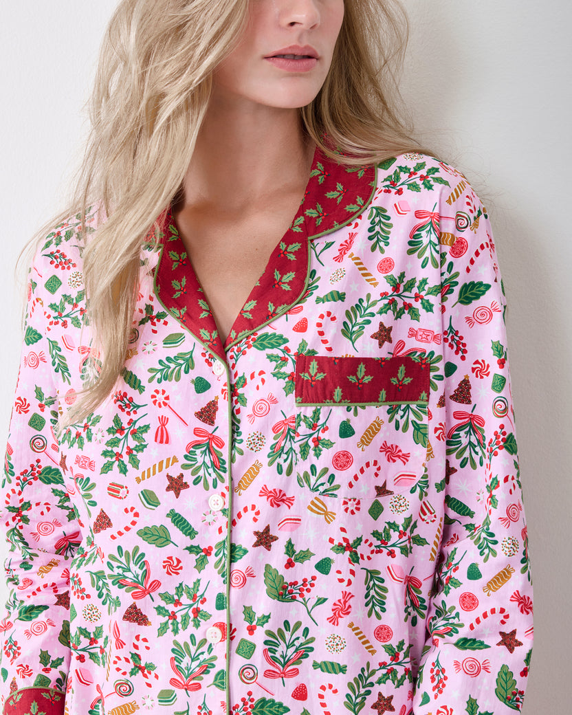 Close front view of the Candy Pink Sweet Tooth pajama top with a red printed collar, cuffs, chest pocket, and candy-and-greenery print.