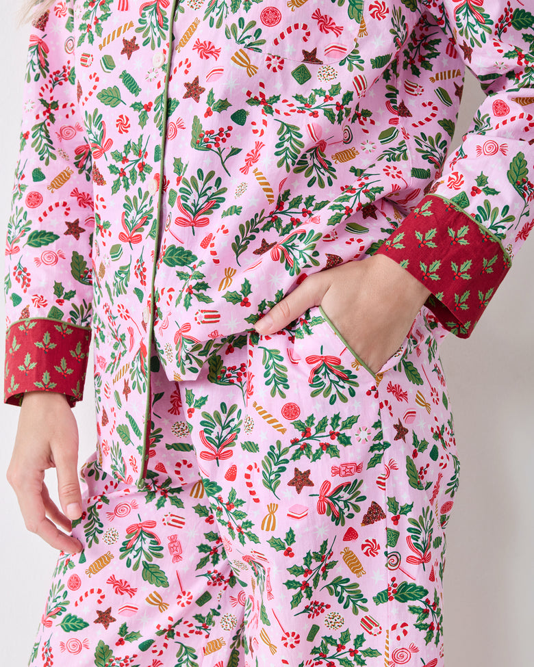 Close view of the Candy Pink Sweet Tooth pajama top and bottoms showing the red contrasting cuff and a side pocket.