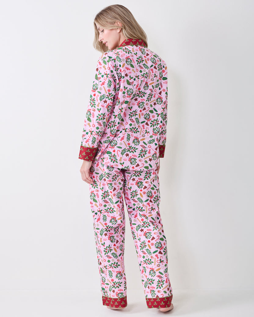 Back view of a person wearing the Candy Pink Sweet Tooth long pajama set, showing the full printed top and bottoms with red ankle bands.
