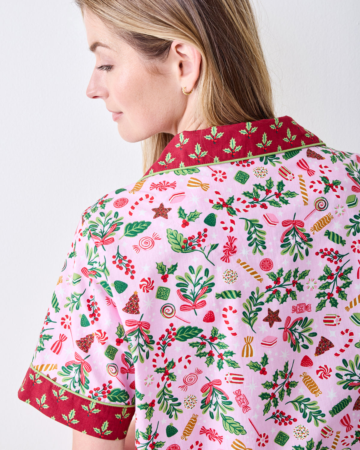Back detail of the Sweet Tooth Candy Pink pajama top, showing the dark red contrast collar and sleeve cuff with the patterned print.