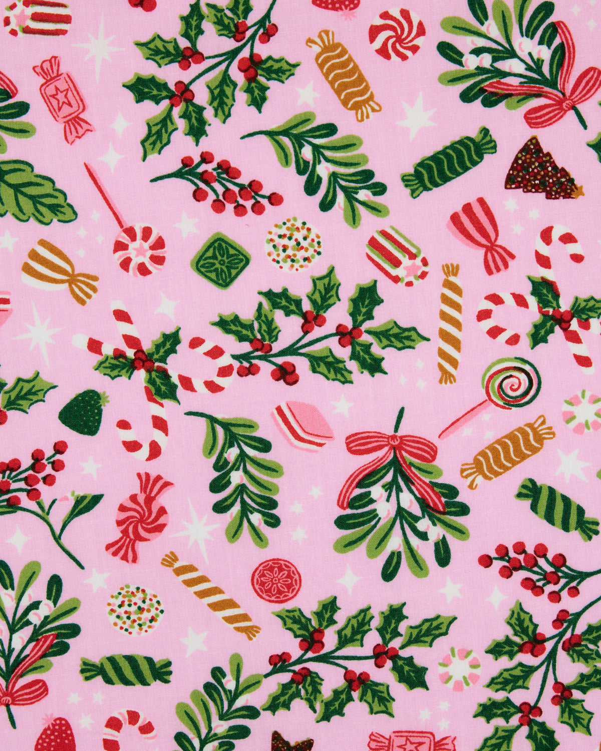 Close-up of the Candy Pink Sweet Tooth print, showing candy, holly, mistletoe, evergreen, and star motifs on a pink background.
