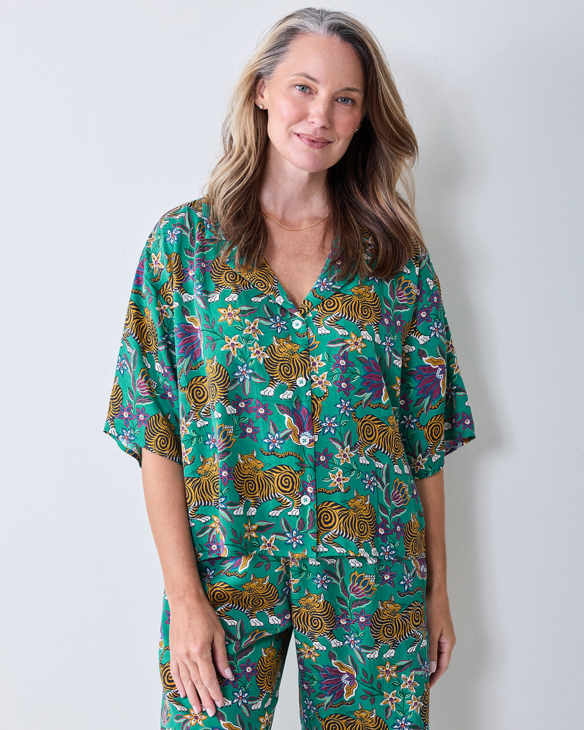 Front view of the Royal Teal Wildest Dreams shirt and pants set, showing the notched collar, button front, and tiger-and-floral print.