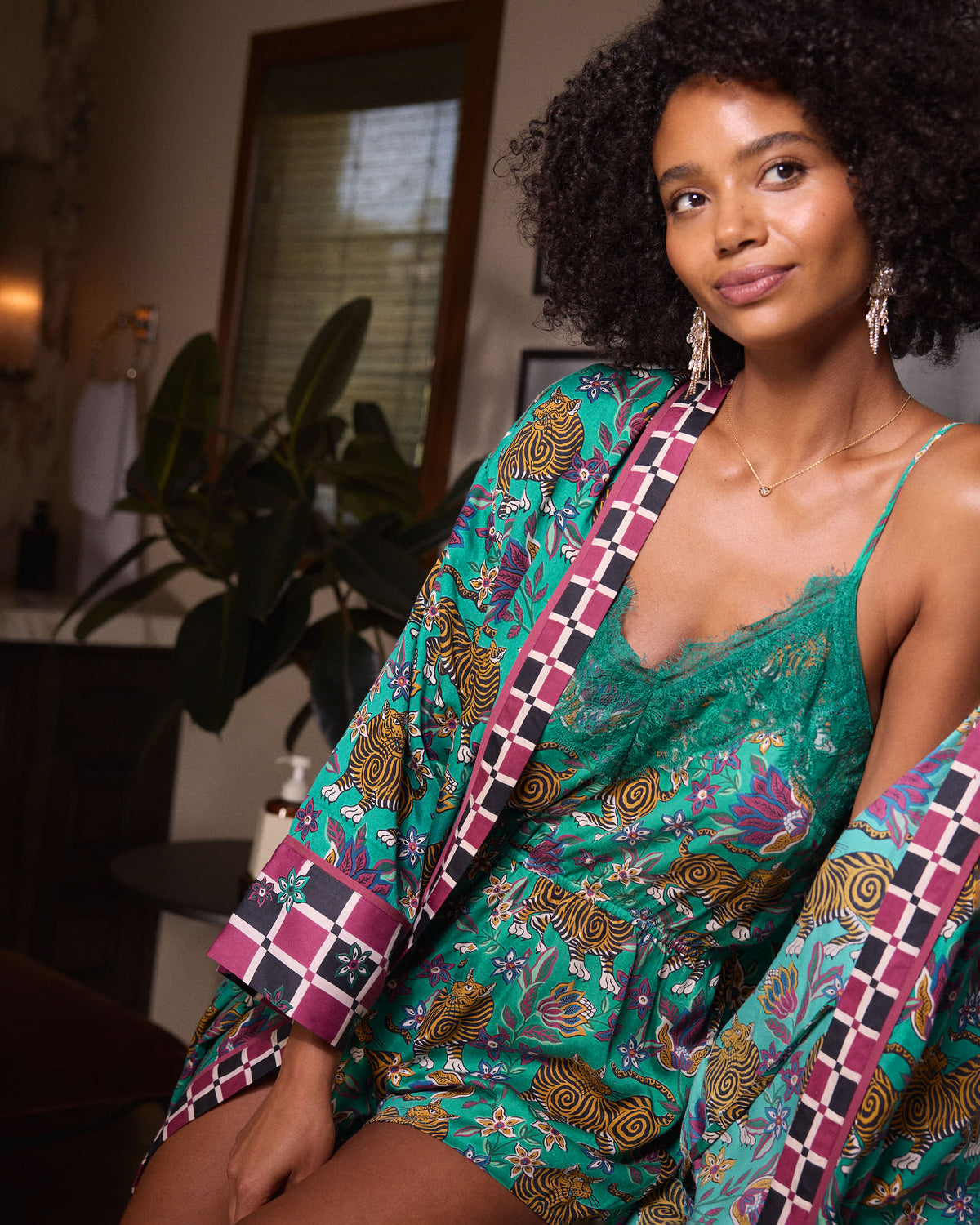 Close view of the Royal Teal Tibetan Tigress Eco Satin Madeline Romper with lace-trimmed camisole neckline and checkered robe trim.