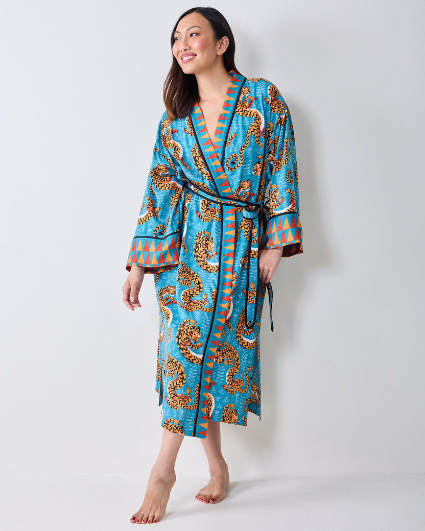 Three-quarter front view of a model wearing a turquoise tiger-print robe with a waist tie.