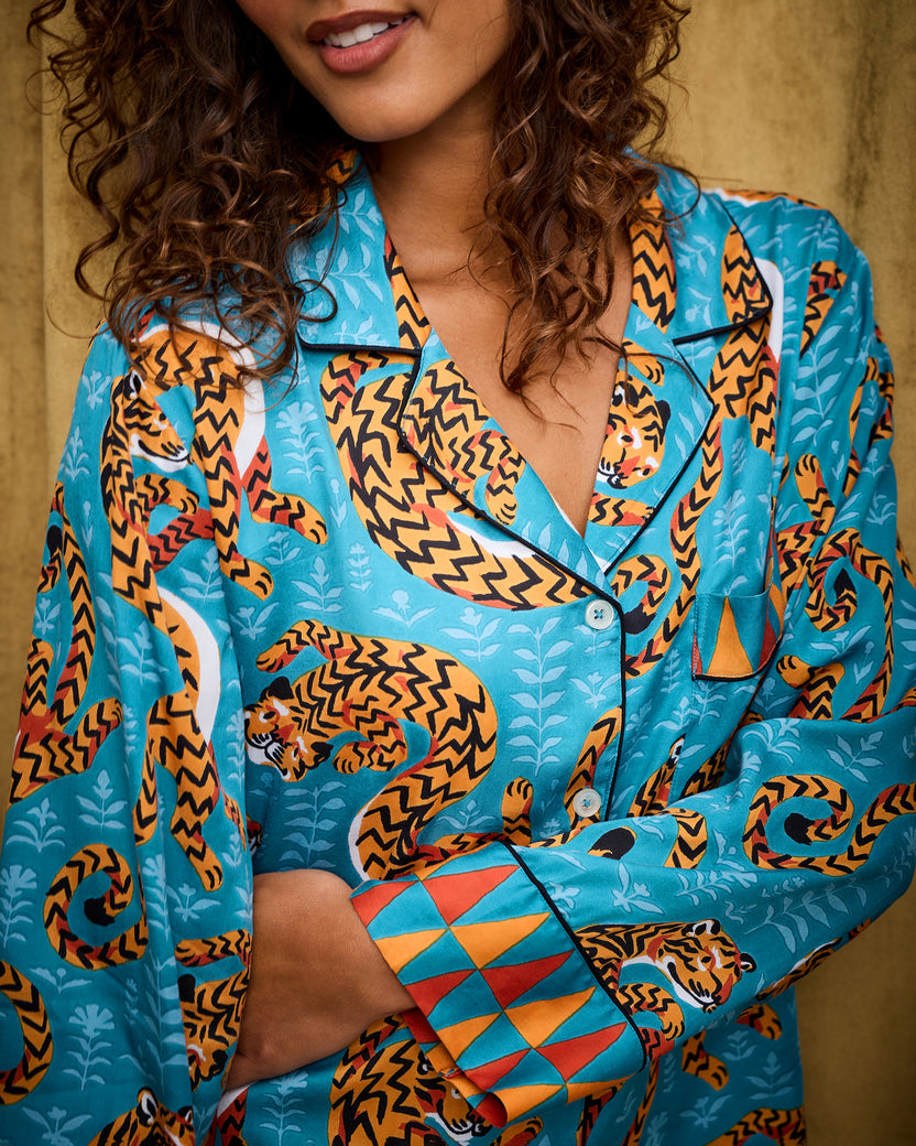 Close view of the Persian Turquoise Twisted Tiger pajama top showing its collar, buttons, chest pocket, tiger print, and geometric cuff.
