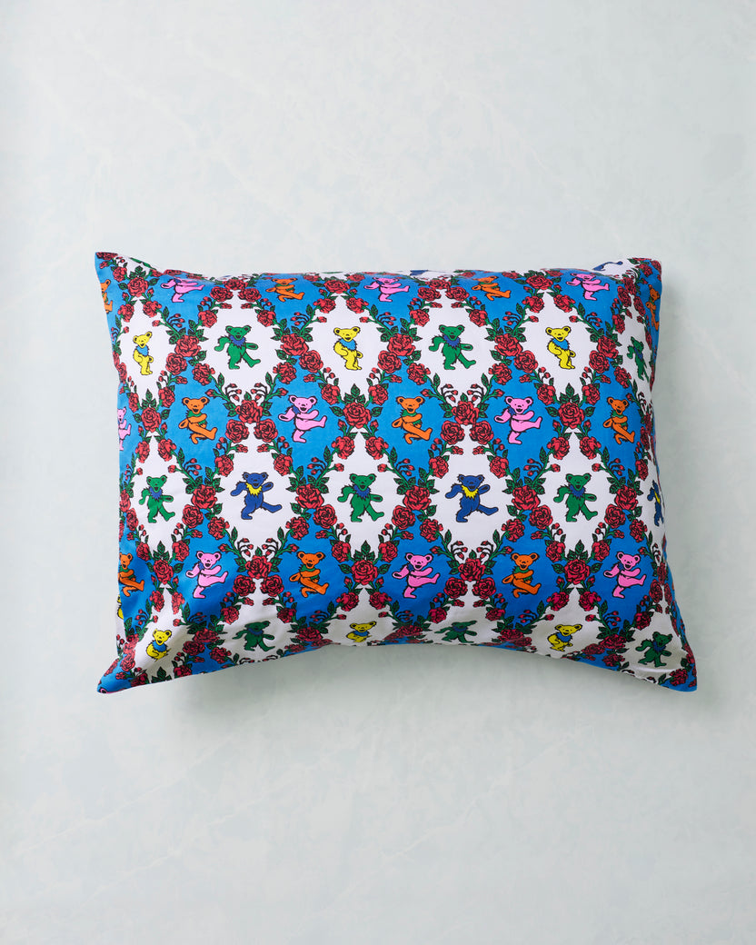 Full view of the Wandering Rose pillowcase with repeating colorful dancing bears and red rose garlands.