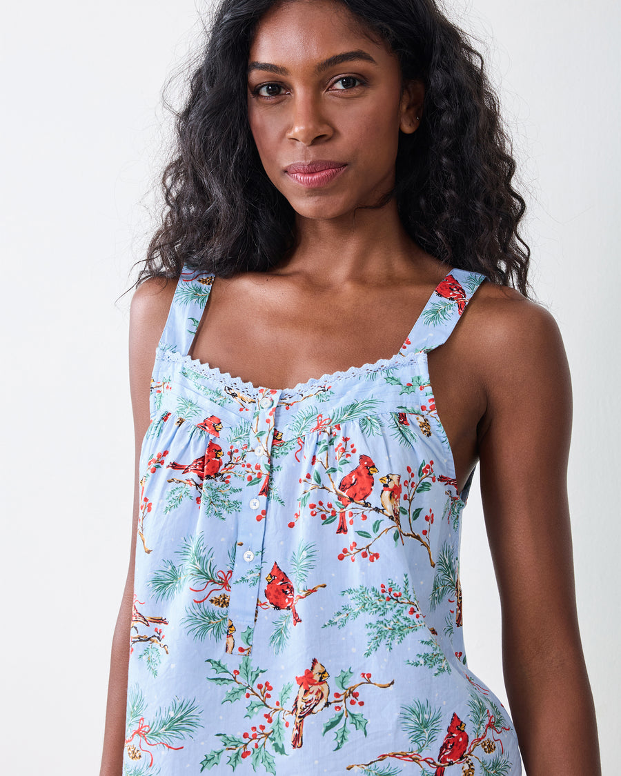 Close-up front view of the frosted blue cropped pants set camisole top with wide straps, lace trim, buttons, and a Winter Cardinals print.