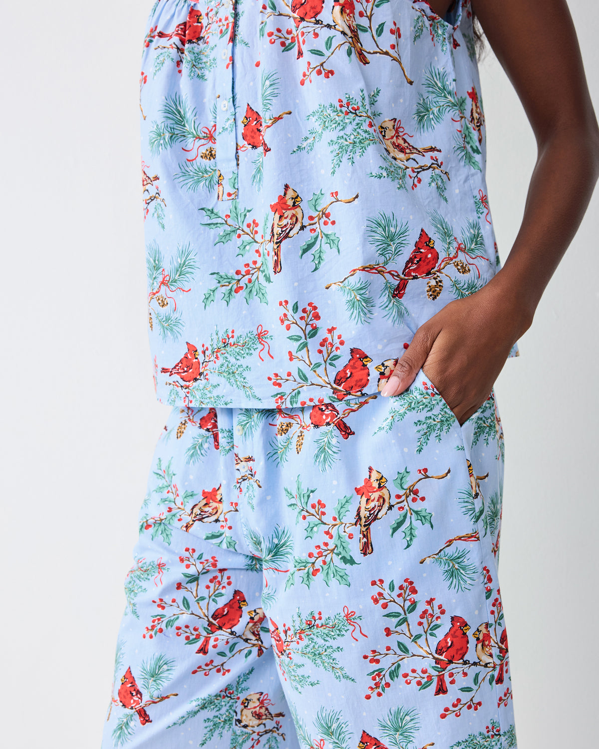 Detail view of the frosted blue cropped pants set showing the printed camisole hem and cropped pants with a side pocket.