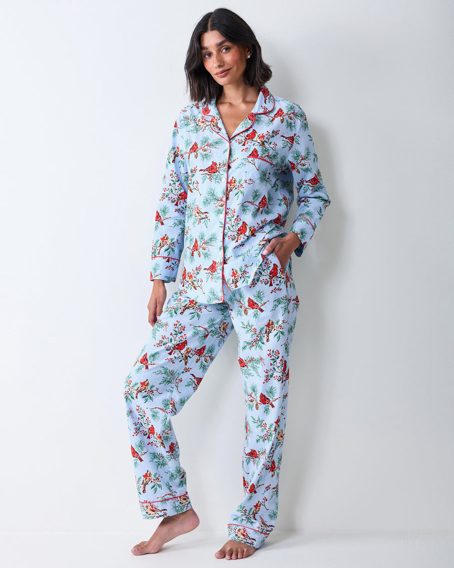 Full front view of the frosted blue Winter Cardinals long pajama set with a red-piped button-front shirt and matching long pants.