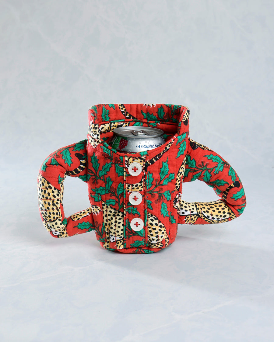 Front view of the Winter Holly Bagheera quilted pajama cozie around a beverage can, with three buttons and two side handles.