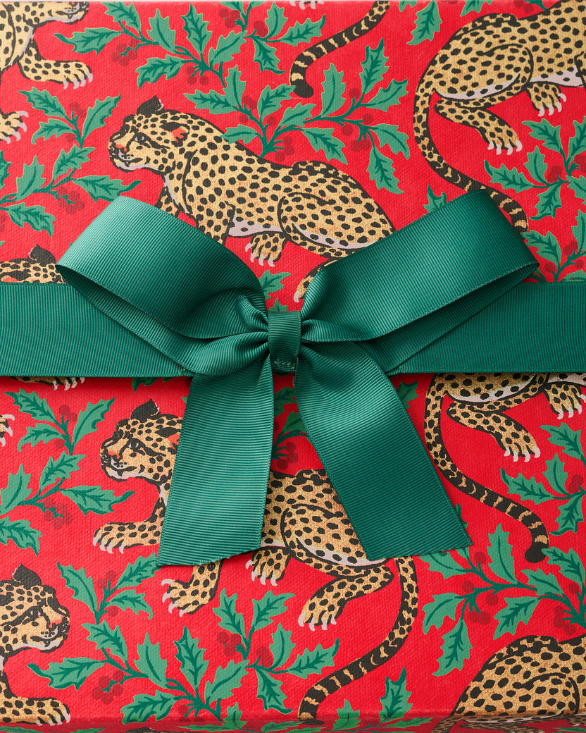 Red Winter Holly Bagheera gift box with a green ribbon and leopard-and-holly print