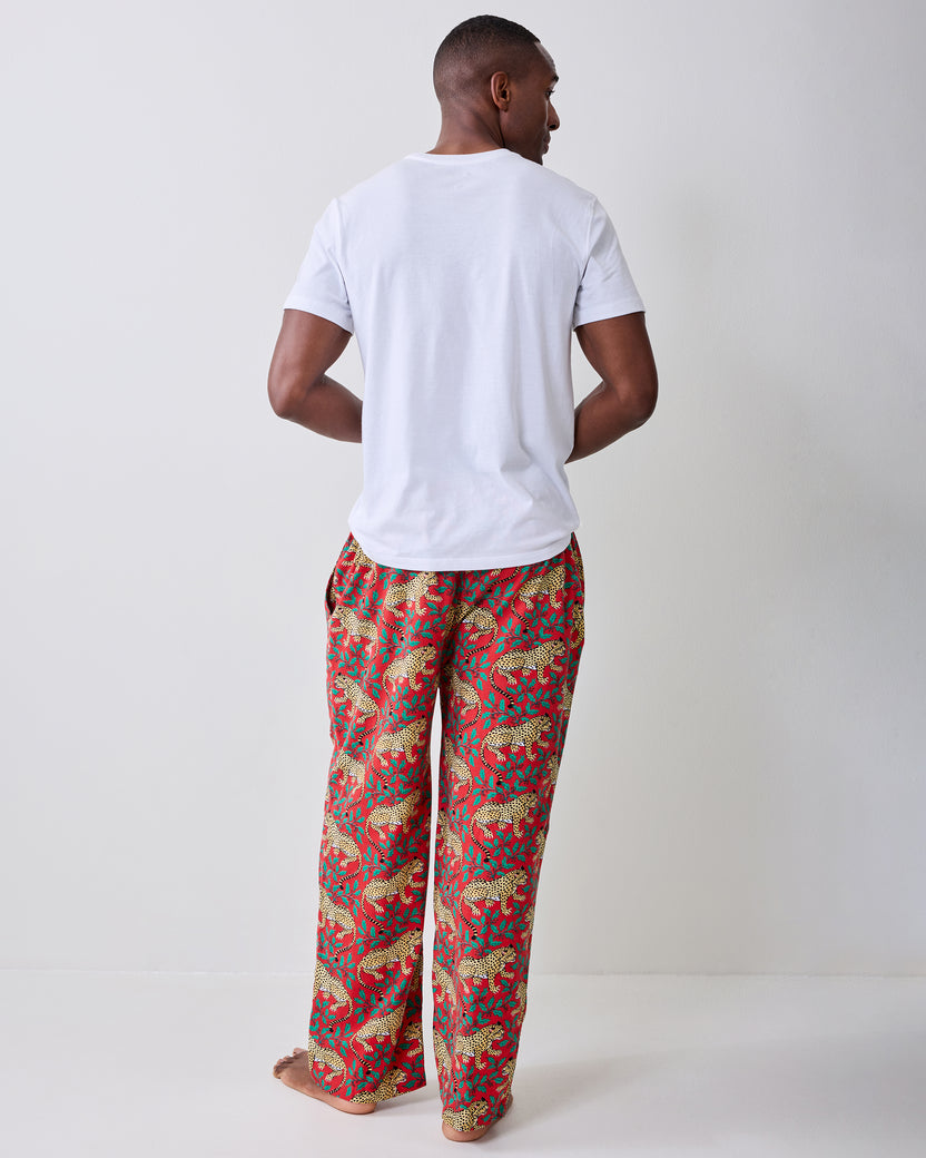 Back view of red pajama pants with a repeating leopard-and-leaf print.