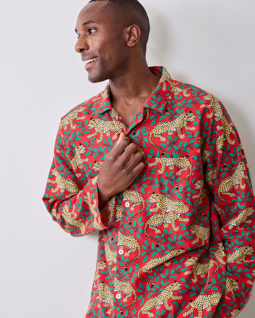 Close-up front view of the red leopard-and-holly pajama shirt with a button-front collar.