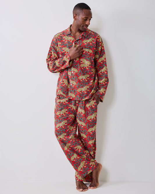 Person wearing the ruby Winter Holly Bagheera long-sleeve pajama top and matching pants, shown standing barefoot.
