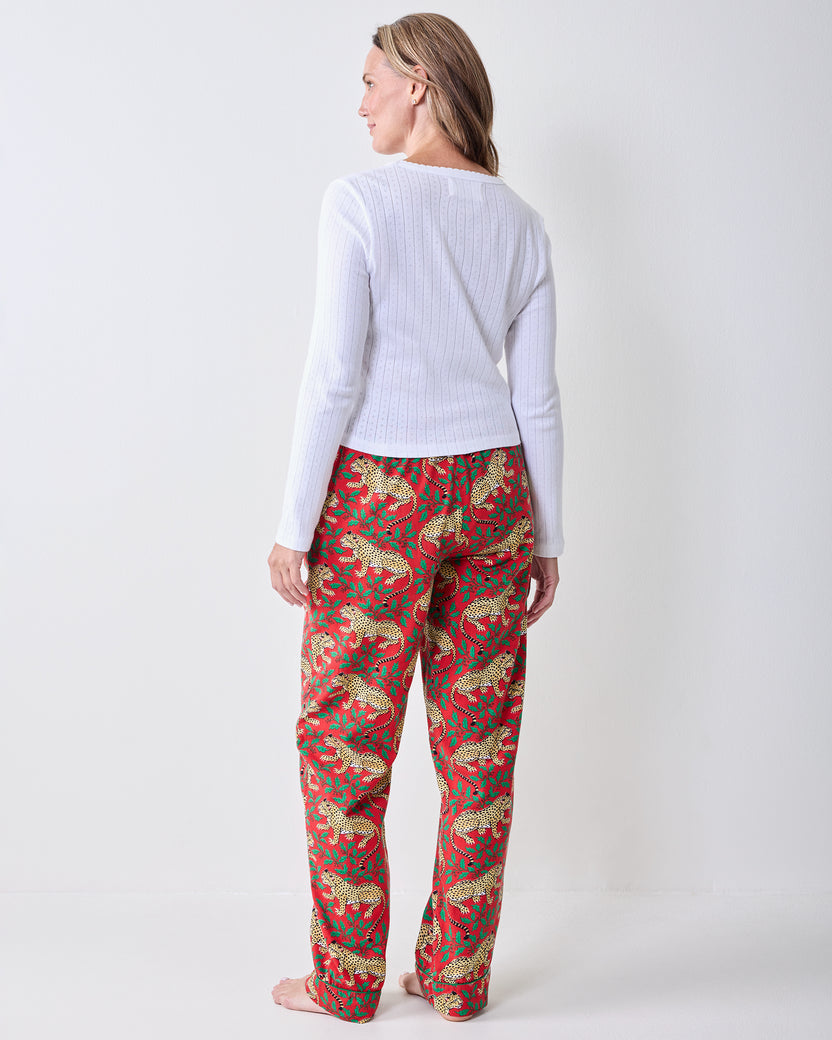 Back view of Winter Holly Bagheera pajama pants showing the full-length legs and red leopard-and-holly print.