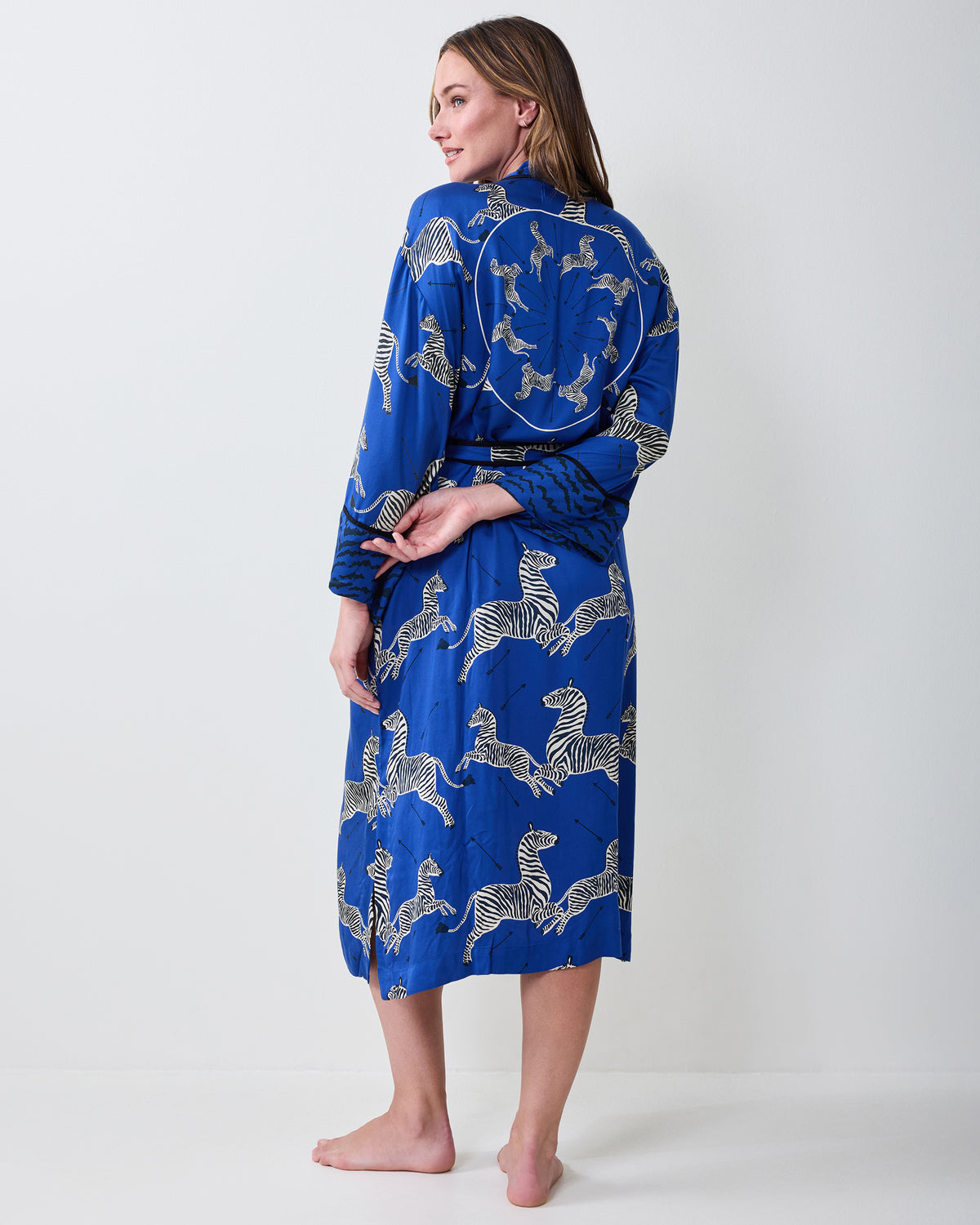 Back view of a denim-blue zebra-print robe with a tied waist.