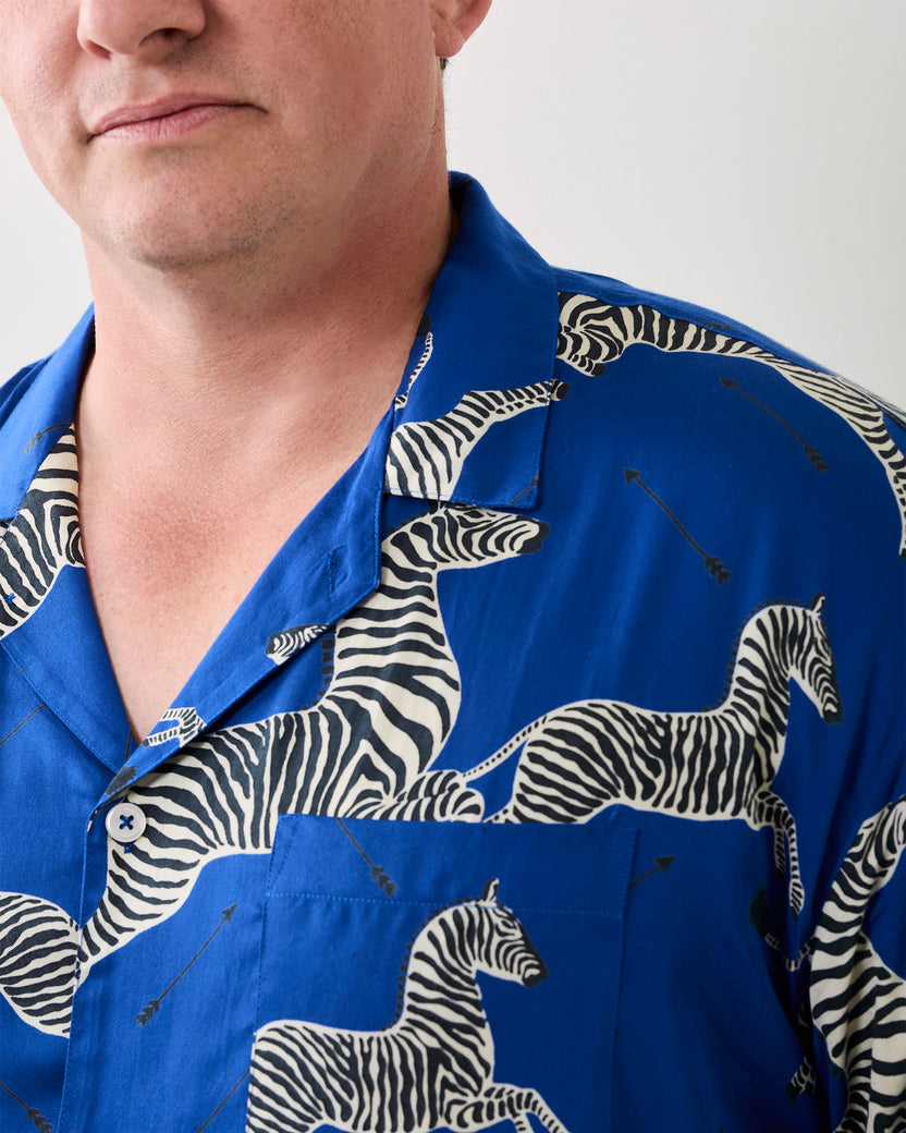 Close-up of a blue long-sleeve pajama shirt with zebra print and a chest pocket.