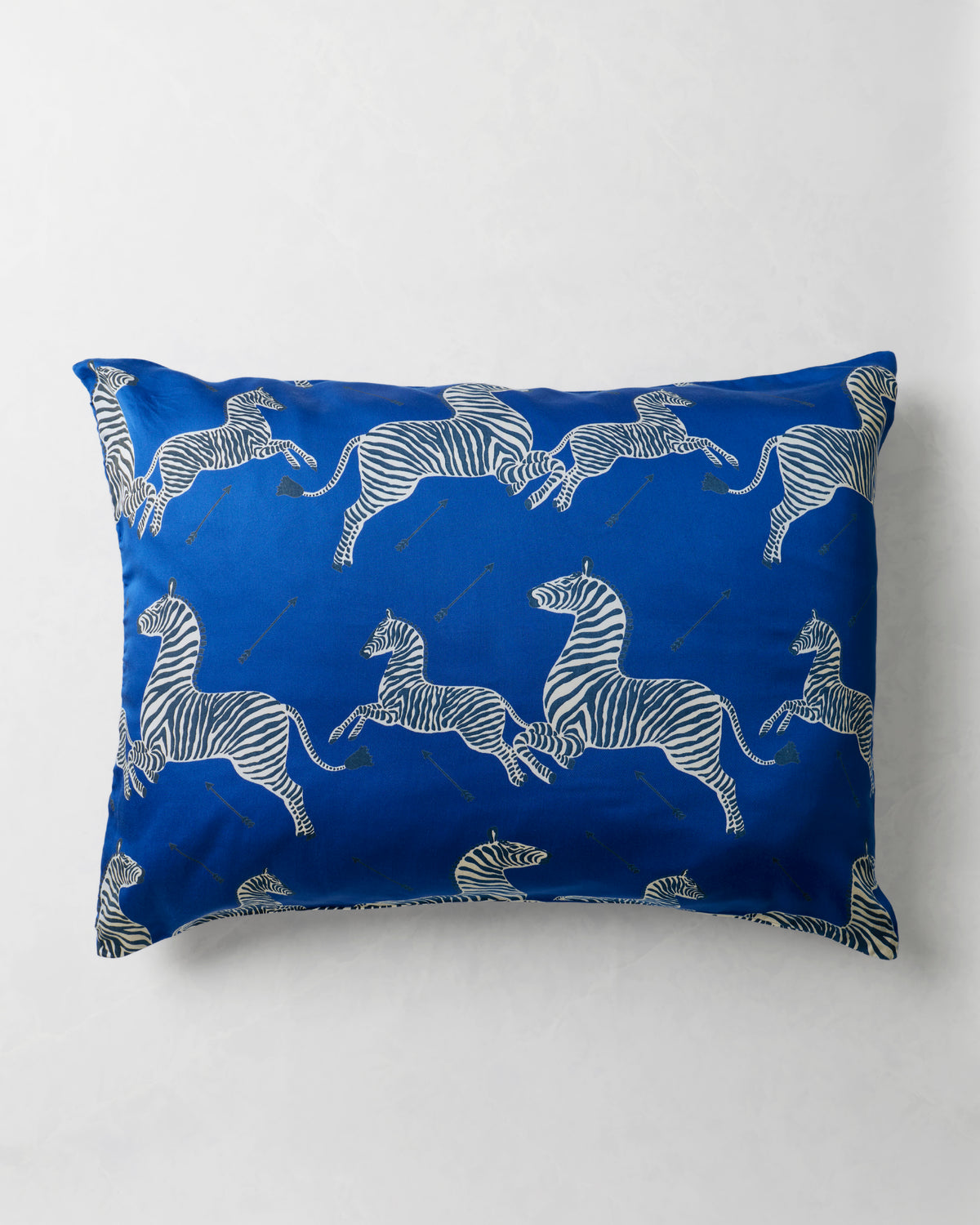 Blue zebra-and-arrow pillowcase displayed flat against a white background.