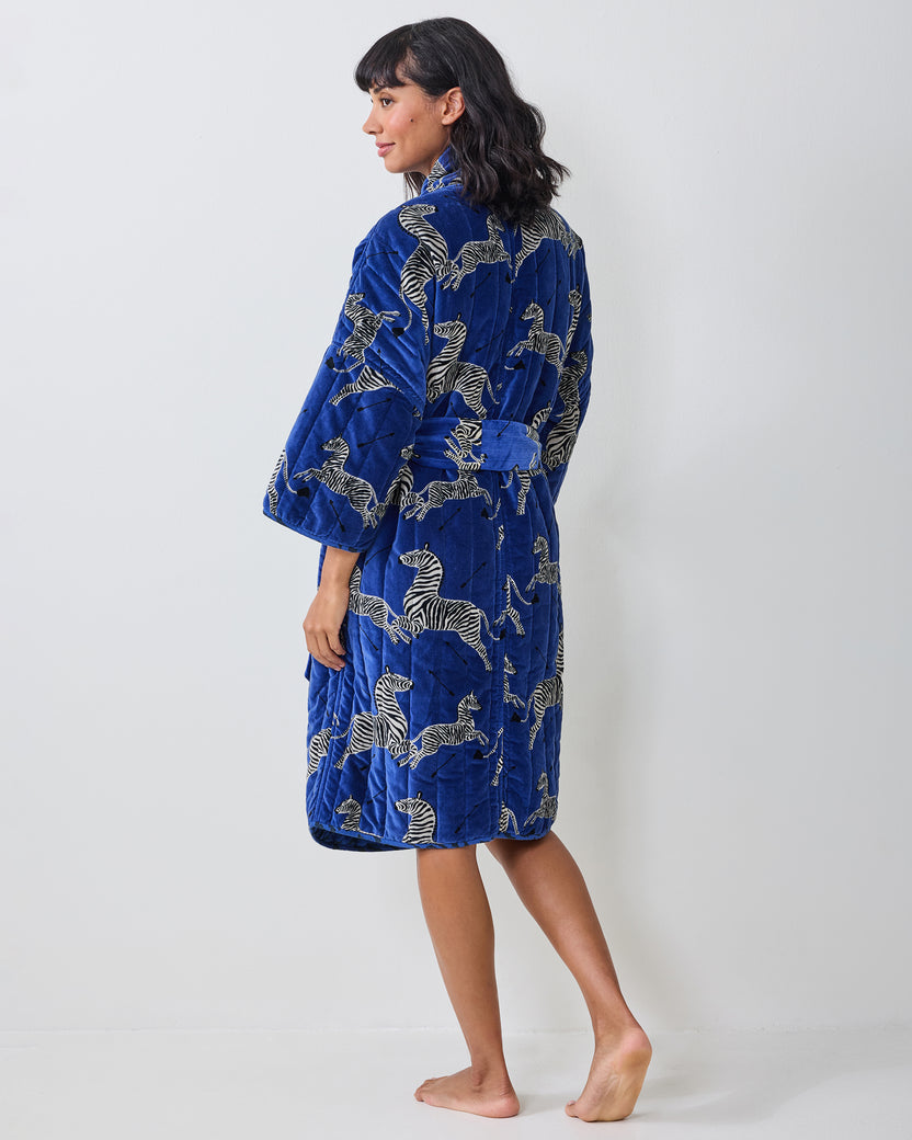 Blue quilted robe with a zebra print, shown from the back and side on a model.