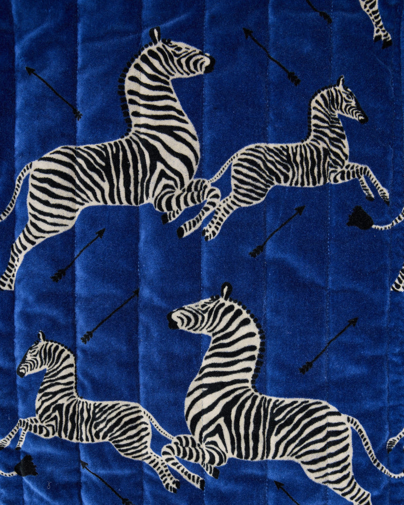 Close-up of the blue zebra-and-arrow print used on the oversized pouch duo.