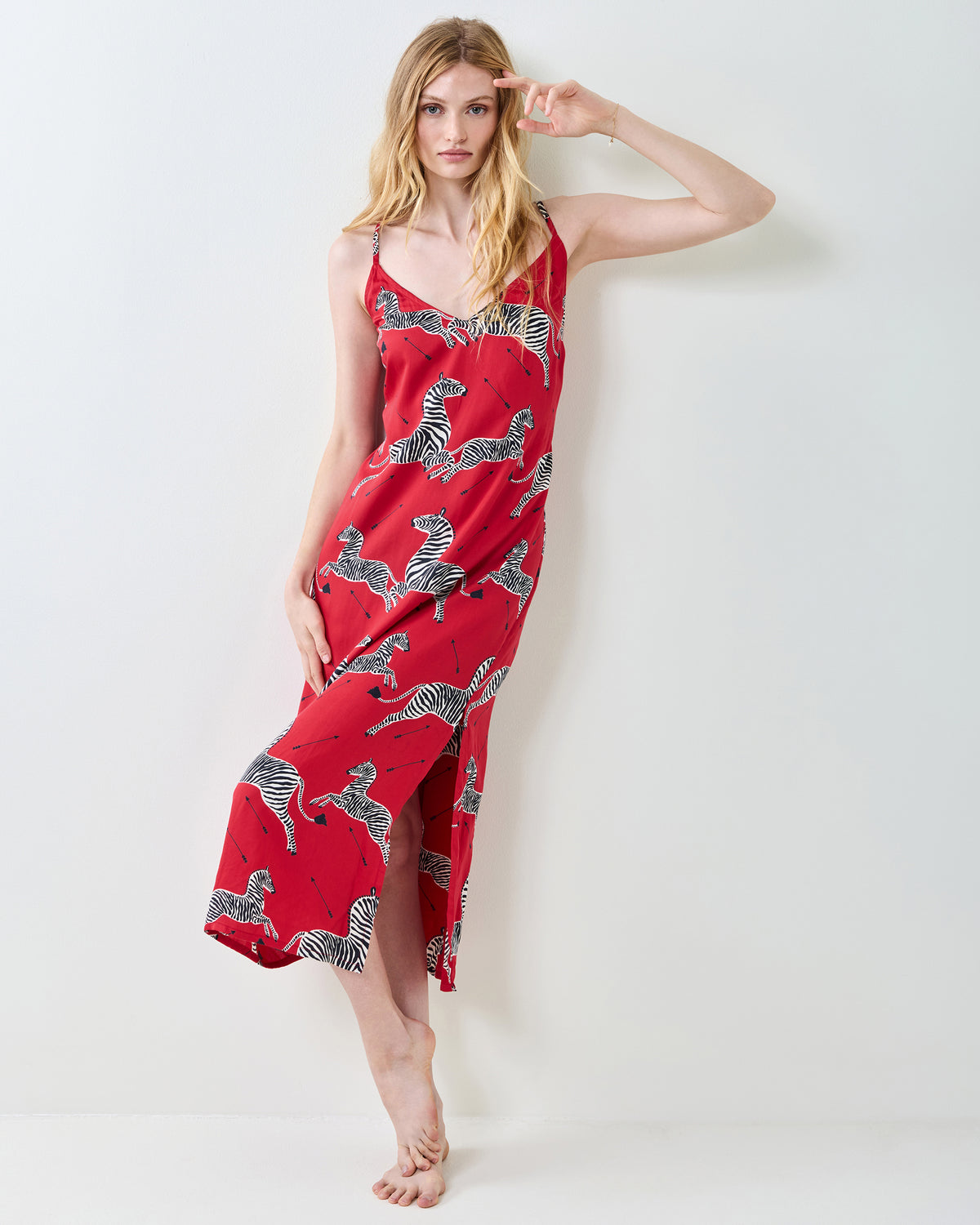 Front view of a red zebra-print nightie with thin straps and a flowing skirt.