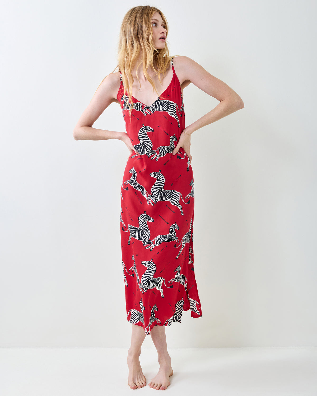 Back view of a person wearing a red zebra-print nightie with thin shoulder straps.