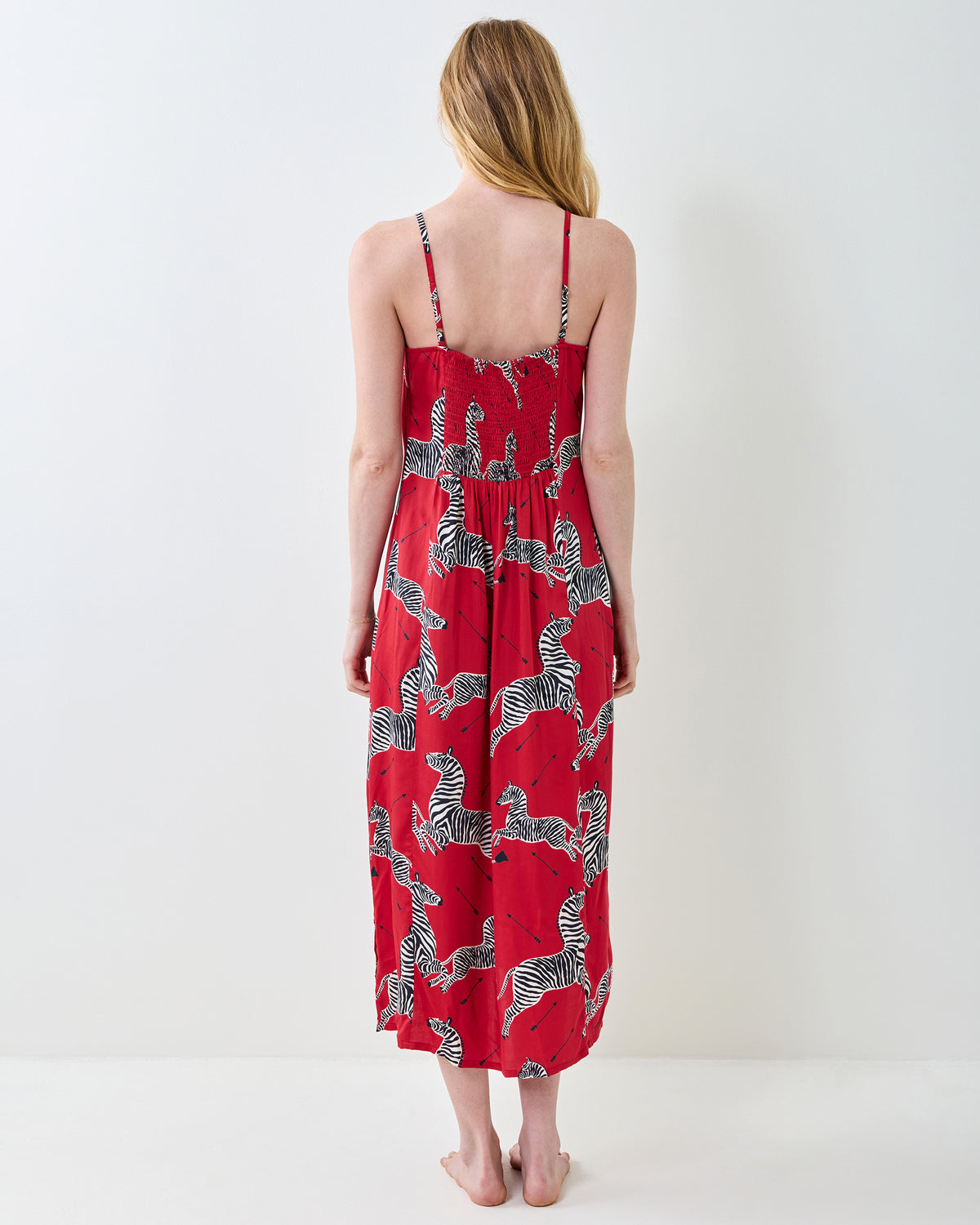 Back view of a red zebra-print nightie with thin straps and a gathered waist.