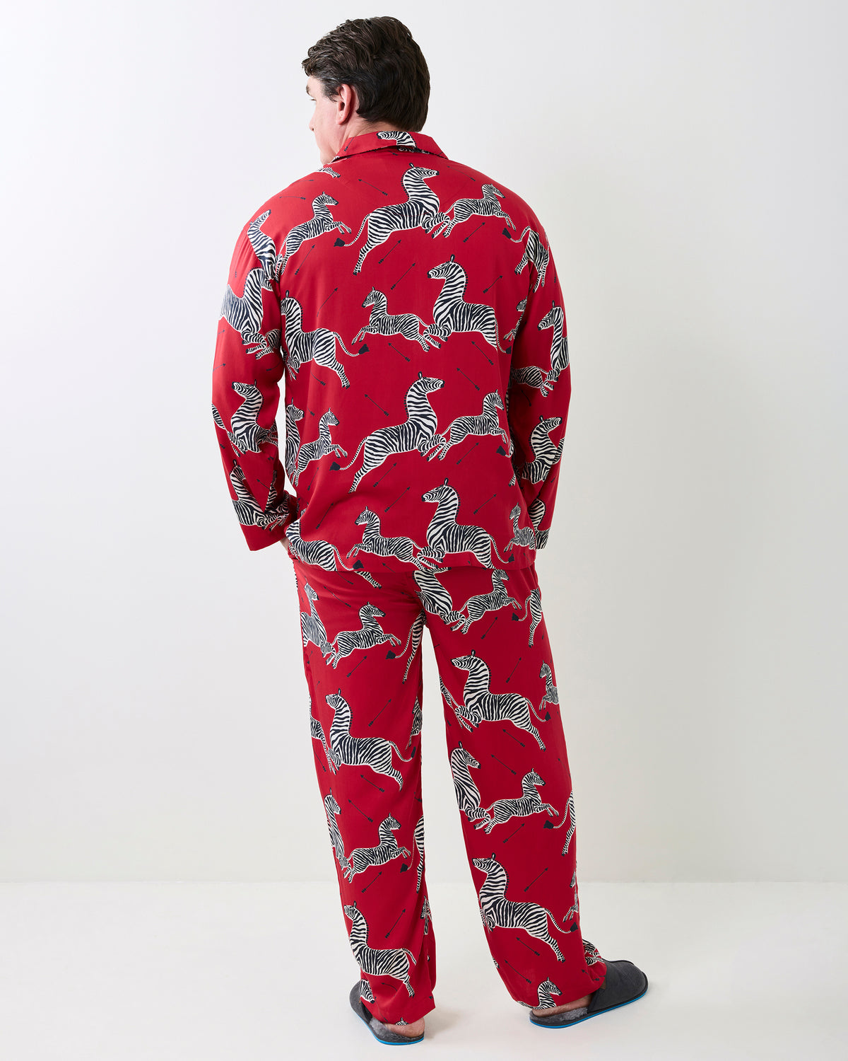 Back view of the red long-sleeve pajama shirt and matching pants with a black-and-white zebra print.