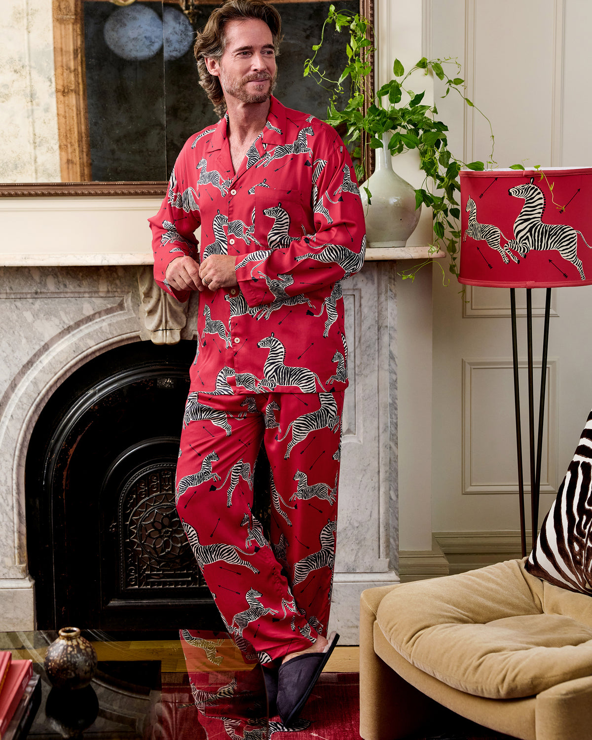 Full-length front view of a red long-sleeve pajama shirt and pants with a black-and-white zebra print.