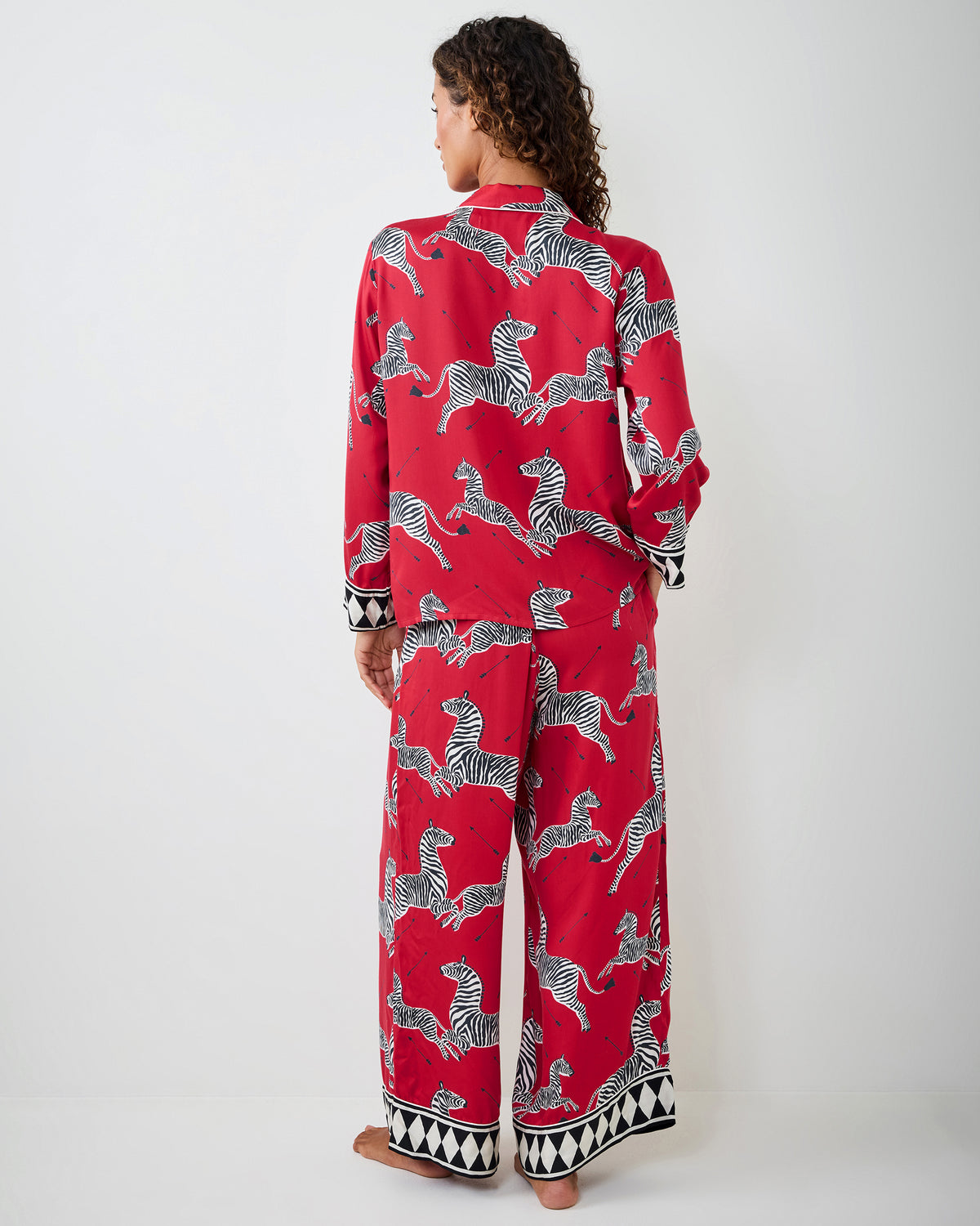 Back view of a person wearing the red zebra-print pajama set, showing the rear shirt and pants.