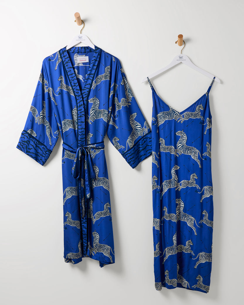 Denim blue zebra-print robe and matching camisole nightie hanging side by side.