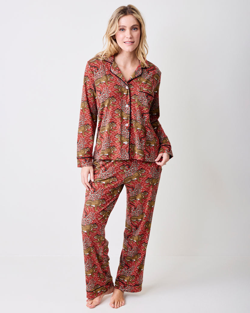 Full view of the scarlet Bagheera long pajama set with a collared button-front top and matching pants in a leopard-and-leaf print.