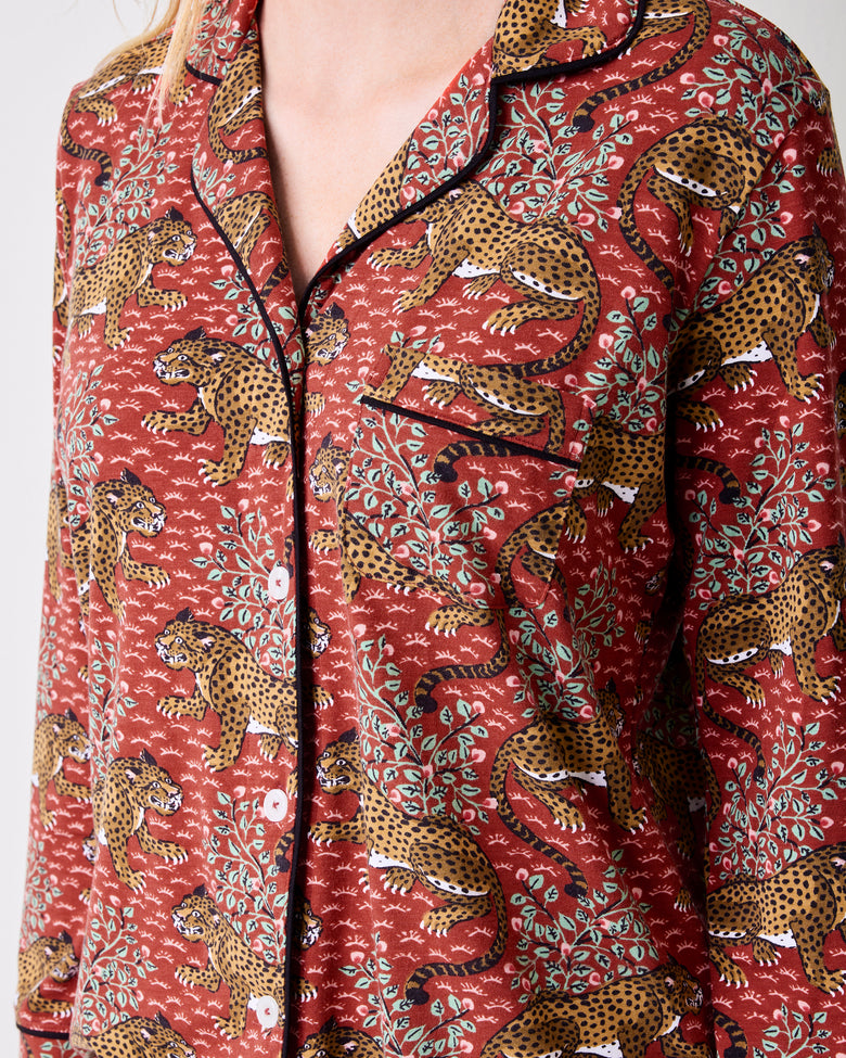 Close-up of the scarlet Bagheera long pajama top with leopard-and-leaf print, black piping, and button front.