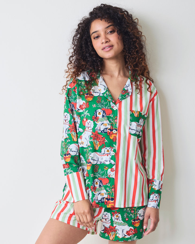 Front view of the Good Dog Christmas boxer pajama set with a long-sleeve split-print top and coordinating shorts featuring stripes and dog-and-poinsettia motifs.