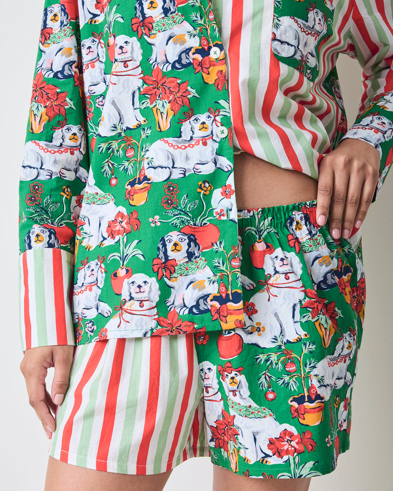 Close view of the Good Dog Christmas Reese boxer pajama set, showing the green dog-and-poinsettia print, striped long sleeves, and coordinating shorts.