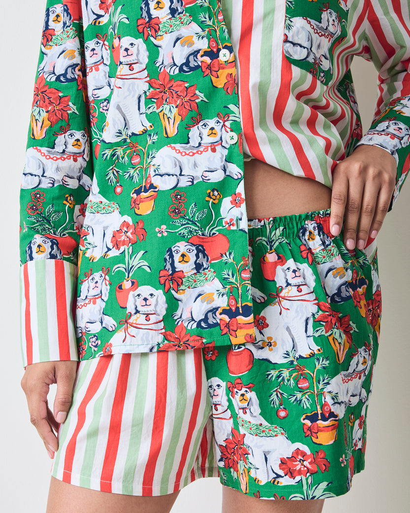 Close view of the Good Dog Christmas Reese boxer pajama set, showing the green dog-and-poinsettia print, striped long sleeves, and coordinating shorts.